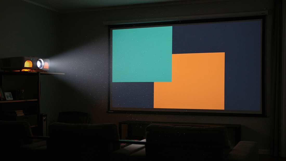 Projector running in a darkened home theatre with its beam visible across the room